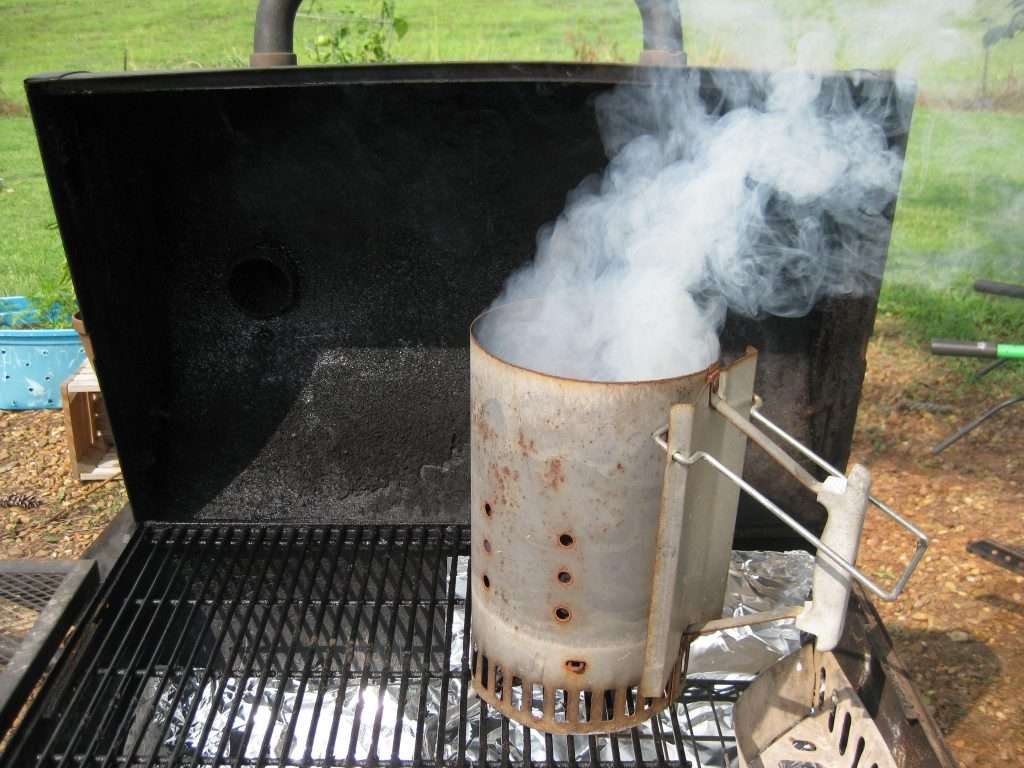 weber chimney starter on a charcoal grill