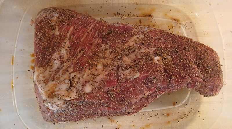 a seasoned tri-tip on a plate